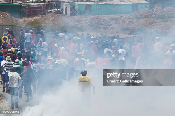 Angry farm workers in De Doorns, on January 9 in Cape Town, South Africa. Police let loose tear gas during violent demonstrations.