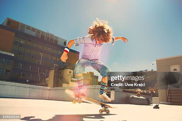 boy performing jump on skateboard - boys sport pants stock pictures, royalty-free photos & images