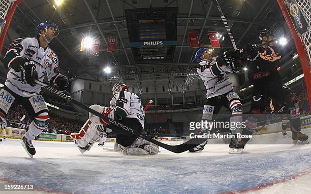 Ivan Ciernik of Hannover battles for position with Justin Forrest of Augsburg in front of the net during the DEL match between Hannover Scorpions and...