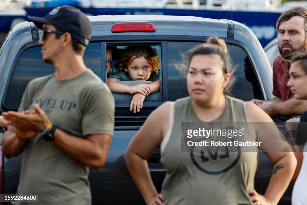 Maalaea, Maui, Thursday, August 10, 2023 - Lianu and Zeran Harris look on as volunteers watch truckloads of donated food and supplies depart for...