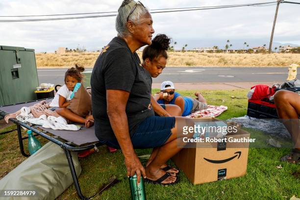 Maalaea, Maui, Thursday, August 10, 2023 - Noe Lopes sits with her granddaughter Leilani and great granddaughter Kawehi as the sun sets on their...