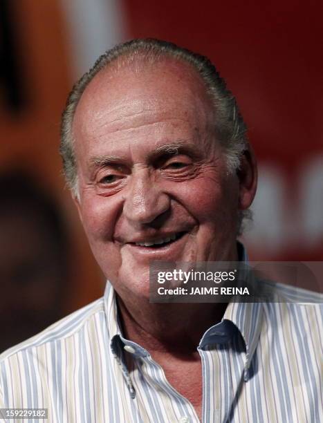 Spain's King Juan Carlos smiles during the trophy ceremony of the 29th Copa del Rey regatta at Ses Voltes Park on August 7, 2010. The Royal Family...