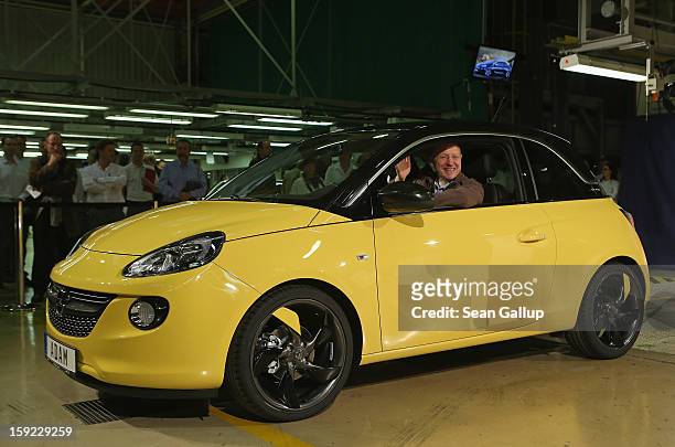 Steve Girsky, General Motors Vice Chairman and head of GM Europe, sits in an Opel Adam car fresh from the assembly line as factory workers look on...