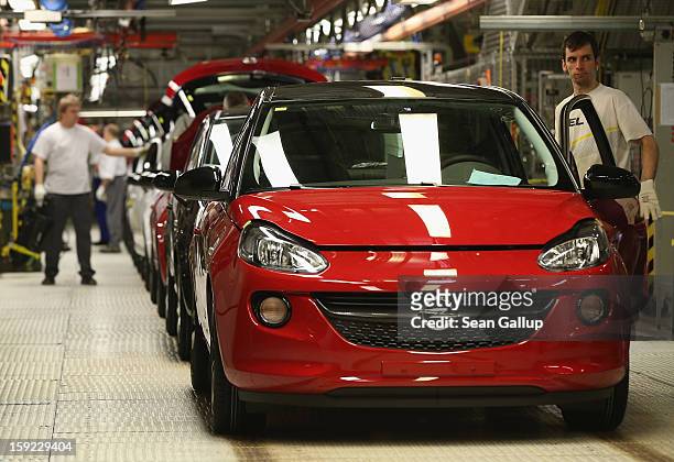 Worker checks a finished Opel Adam car at the assembly line shortly after a celebration to mark the launch of the new Opel compact car at the Opel...