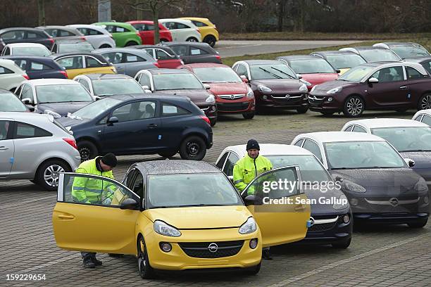 Worker check a finished Opel Adam car at a factory parking lot shortly after a celebration to mark the launch of the new Opel compact car at the Opel...