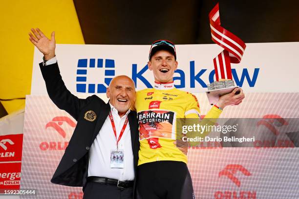 Czesław Lang of Poland and Matej Mohorič of Slovenia and Team Bahrain - Victorious celebrate at podium as Yellow leader jersey winner during the 80th...