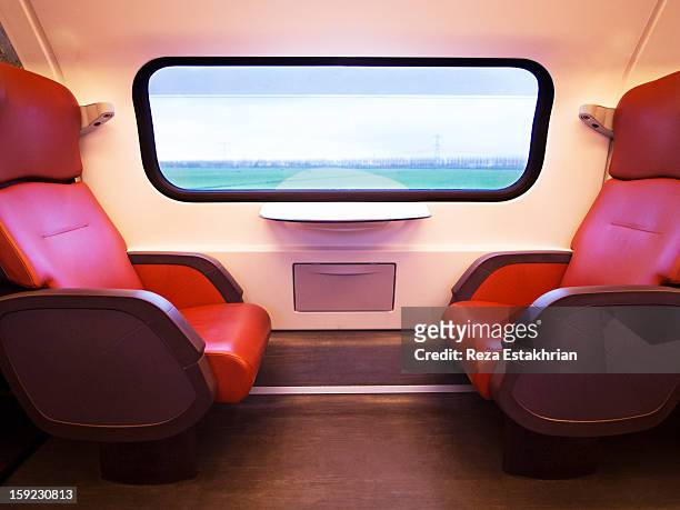 empty train seats as scenery goes by - train interior stock pictures, royalty-free photos & images
