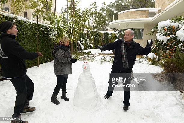 In this handout provided by the GPO, Israeli Prime Minister Benjamin Netanyahu enjoys the snow with his family on January 10, 2013 in Jerusalem,...