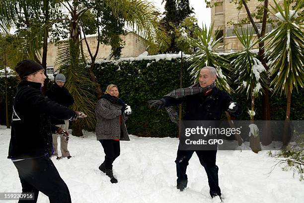 In this handout provided by the GPO, Israeli Prime Minister Benjamin Netanyahu enjoys the snow with his family on January 10, 2013 in Jerusalem,...