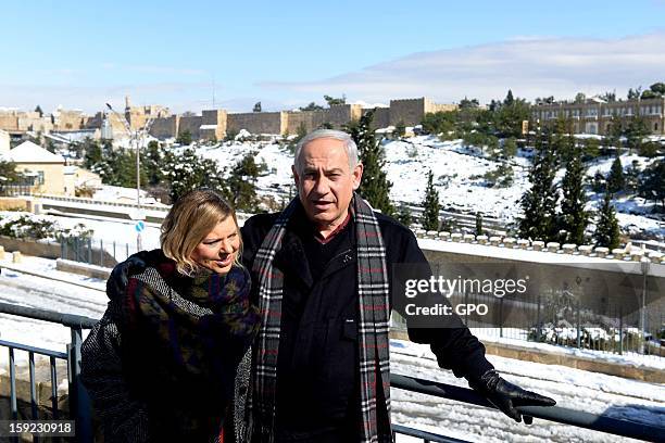 In this handout provided by the GPO, Israeli Prime Minister Benjamin Netanyahu enjoys the snow with his family on January 10, 2013 in Jerusalem,...