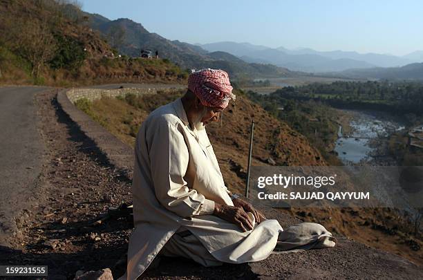 Pakistani Kashmiri prays towards Mecca on a roadside which leads to the town of Titrinot, some 30 kilometers north of Battal sector close of...