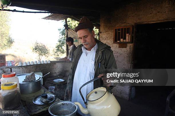 Pakistani Kashmiri tea vendor makes a brew for customers at his stall on the way to the town of Titrinot, some 30 kilometers north of Battal sector...