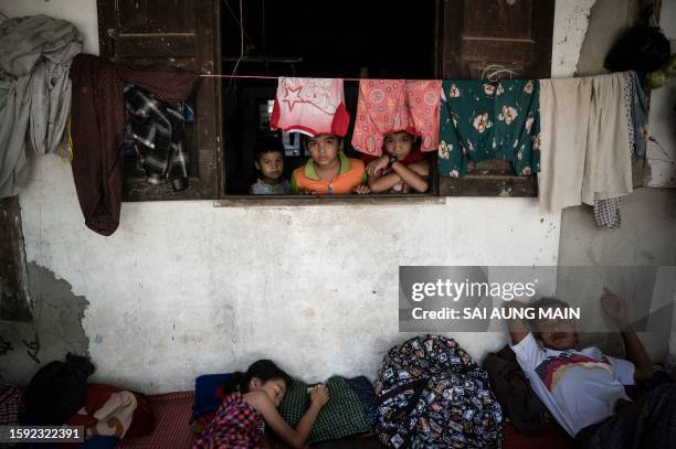 Residents displaced by flooding take shelter in a monastery compound following monsoon rains in Bago township, Bago region, on August 11, 2023....