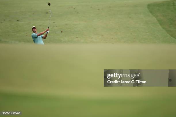 Adam Scott of Australia plays a shot on the first hole during the second round of the Wyndham Championship at Sedgefield Country Club on August 04,...