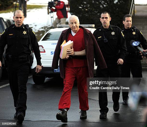 Jerry Sandusky is escorted to the Centre County Courthouse in Bellefonte, Pennsylvania, for a hearing on Thursday, January 10, 2013.