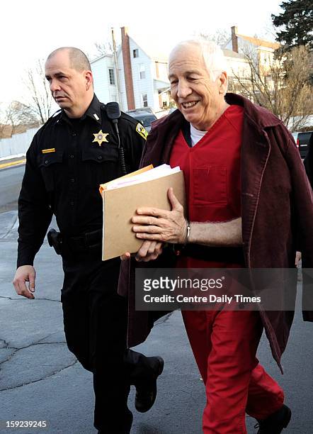 Jerry Sandusky is escorted to the Centre County Courthouse in Bellefonte, Pennsylvania, for a hearing on Thursday, January 10, 2013.