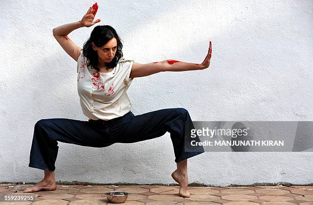 Inbal Oshman, 32-year-old contemporary dancer from Israel, performs during a preview of 'Attakkalari India Biennial 2013' dance festival in Bangalore...