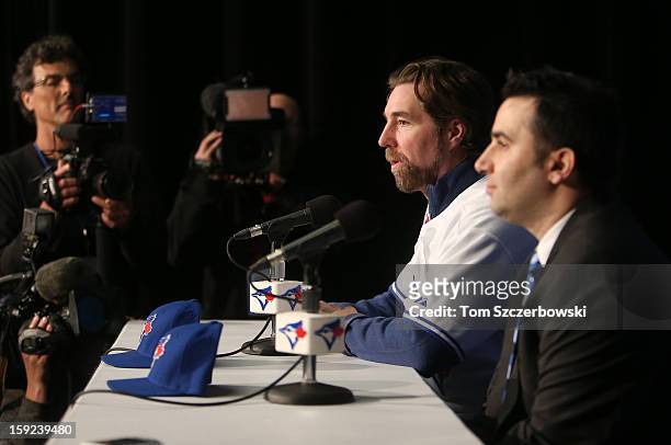 Dickey of the Toronto Blue Jays answers questions from reporters as he is introduced at a press conference next to general manager Alex Anthopoulos...