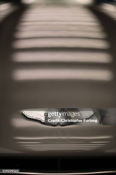 An Aston Martin logo known as the 'Wings' adorns the bonnet of a Vanquish at the company headquarters and production plant on January 10, 2013 in...