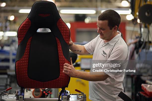 Technician builds the seat for an Aston Martin Vanquish at the company headquarters and production plant on January 10, 2013 in Gaydon, England. The...