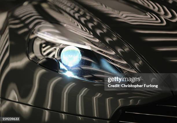 An Aston Martin Vanquish is inspected by hand inside a light booth at the company headquarters and production plant on January 10, 2013 in Gaydon,...