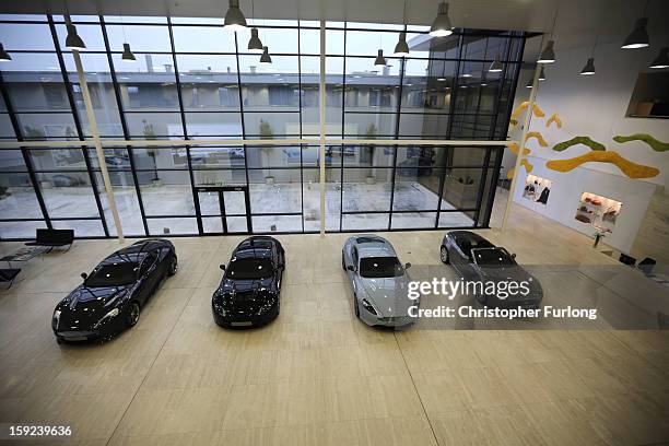 Aston Martin motor cars sit in the foyer at the headquarters and production plant of Aston Martin on January 10, 2013 in Gaydon, England. The iconic...