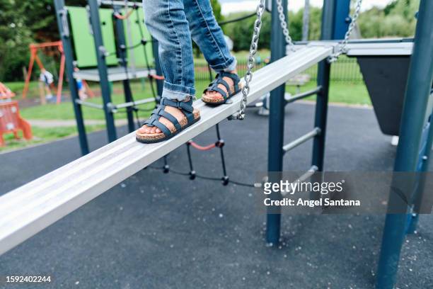 legs of a little girl walking on a playground game - sandal tree stock pictures, royalty-free photos & images