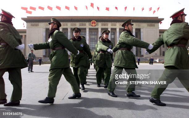 Peoples' Liberation Army soldiers march out from the Great Hall of the People for crowd control and security prior to the opening of the Chinese...