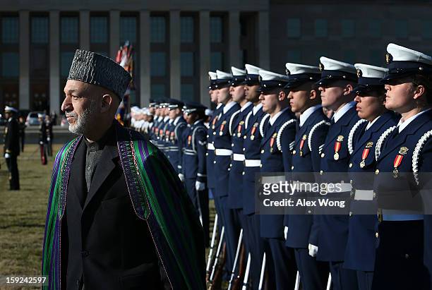 Afghan President Hamid Karzai reviews the honor guards during a full military honors ceremony welcoming Karzai to the Pentagon January 10, 2013 in...