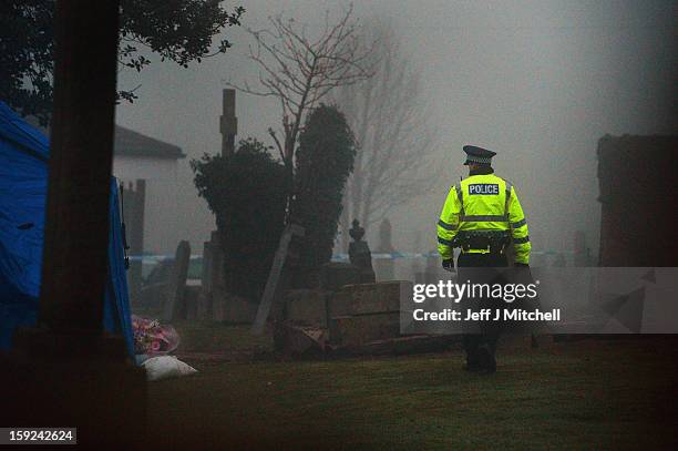 Police officer views the scene as it is confirmed that a grave in Old Monkton cemetery does not contain the body of missing schoolgirl Mora Anderson...