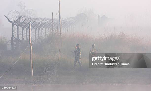 The BSF troops patrolling in thick fog in the riverine area along with the border of Pakistan in Ajnala sector on January 10, 2013 about 45 KMS from...