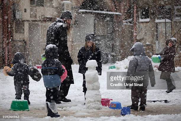 Ultra-orthodox Jews enjoy the snow in the Mea Shearim religious neighborhoodon January 10, 2013 in Jerusalem, Israel.