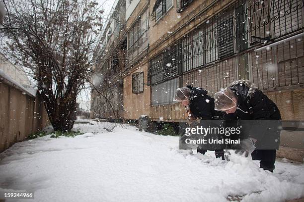 Ultra-orthodox Jewish girls enjoy the snow in the Mea Shearim religious neighborhoodon January 10, 2013 in Jerusalem, Israel.