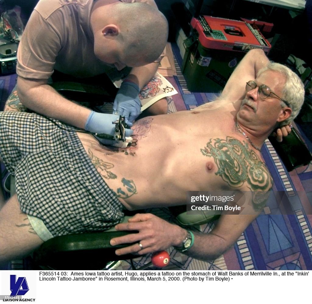 Ames Iowa tattoo artist, Hugo, applies a tattoo on the stomach of... News  Photo - Getty Images