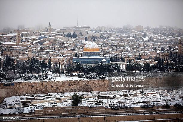 Snow covers the Dome of the Rock at the Al-Aqsa mosque compound on January 10, 2013 in the old city in east Jerusalem, Israel.