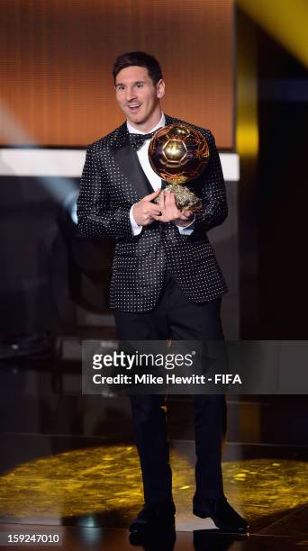 Lionel Messi of Argentina holds the trophy alloft after winning the FIFA Ballon d'Or for a fourth consecutive time during FIFA Ballon d'Or Gala 2012...