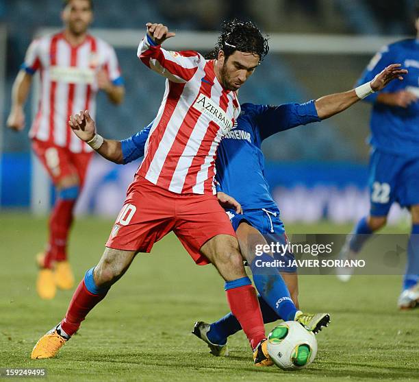 Atletico Madrid's Turkish midfielder Arda Turan vies with Getafe's midfielder Jaime Gavilan during the Spanish Copa del Rey round of 16, second leg,...