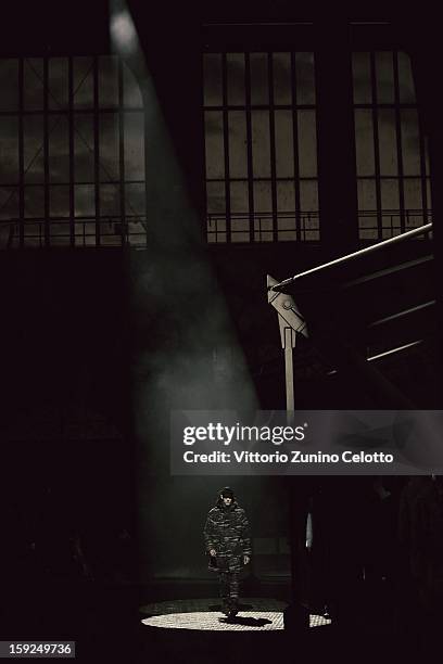 Model walks the runway during the Kenzo fashion show as part of Pitti Immagine Uomo 83 at Mercato Centrale on January 10, 2013 in Florence, Italy.