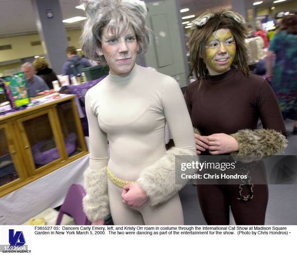 Dancers Carly Emery, left, and Kristy Orr roam in costume through the International Cat Show at Madison Square Garden in New York March 5, 2000. The...