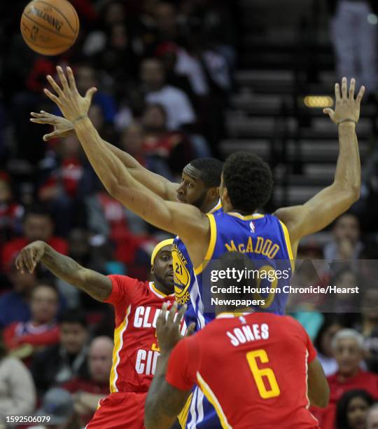 Golden State Warriors guard Ian Clark and forward James Michael McAdoo reach for a rebound during the second half of the Rockets' 114-110 loss to the...