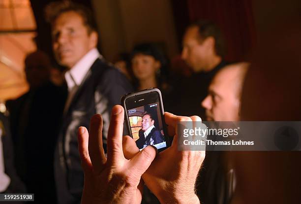 Guest photographs Entertainer and Singer Dieter Bohlen who presents his wallpaper collection "Dieter Bohlen - it's different" during a party in the...