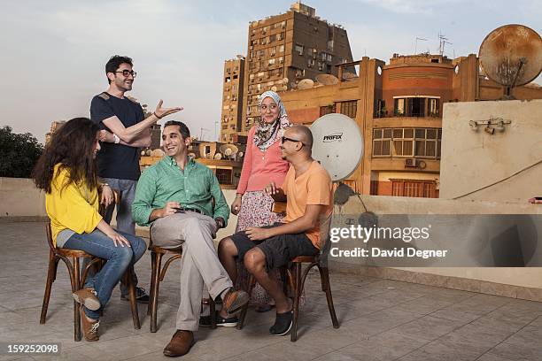 Bassem Youssef sits with some of his researchers and writers on top of their temporary offices while their new offices are being renovated, on...