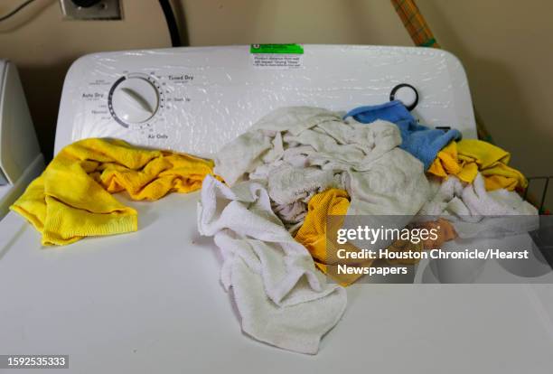 Towels wait for the next load of laundry after being used to clean up Miracle Nails in Meyerland, Tuesday, April 19 in Houston. Employees were at the...