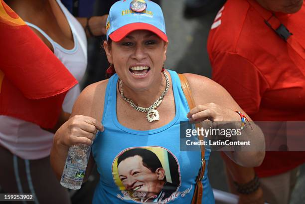 Supporter of Venezuelan President Hugo Chavez poses for a picture during a massive demonstration at Miraflores Presidential Palace on January 10,...