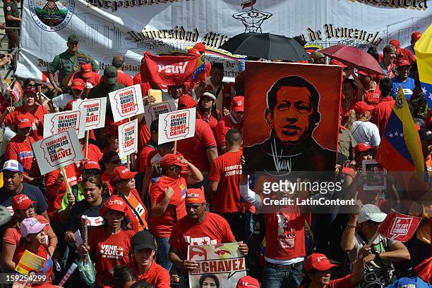 Supporters of Venezuelan President Hugo Chavez hold billboards on January 10, 2013 in Caracas, Venzuela. Chavez is now hospitalized in Cuba due to a...