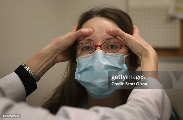 Dr. Anne Furey Schultz examines Alice Corcoran, who was experiencing flu-like symptoms, at Northwestern Memorial Hospital on January 10, 2013 in...