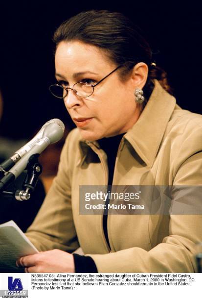Alina Fernandez, the estranged daughter of Cuban President Fidel Castro, listens to testimony at a US Senate hearing about Cuba, March 1, 2000 in...