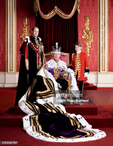 King Charles III, Prince William Prince of Wales and Prince George on the day of the coronation in the Throne Room at Buckingham Palace. The King in...