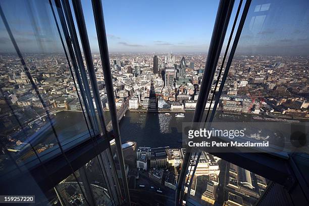 The shadow of the Shard falls over the River Thames and The City of London financial district, as seen from the Shard's viewing platform on January...