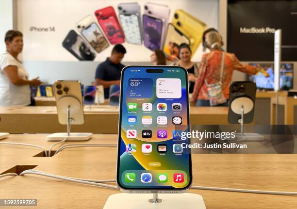 An Apple iPhone 14 is displayed at an Apple Store on August 04, 2023 in Berkeley, California. Shares of Apple stock fell on Friday morning after the...